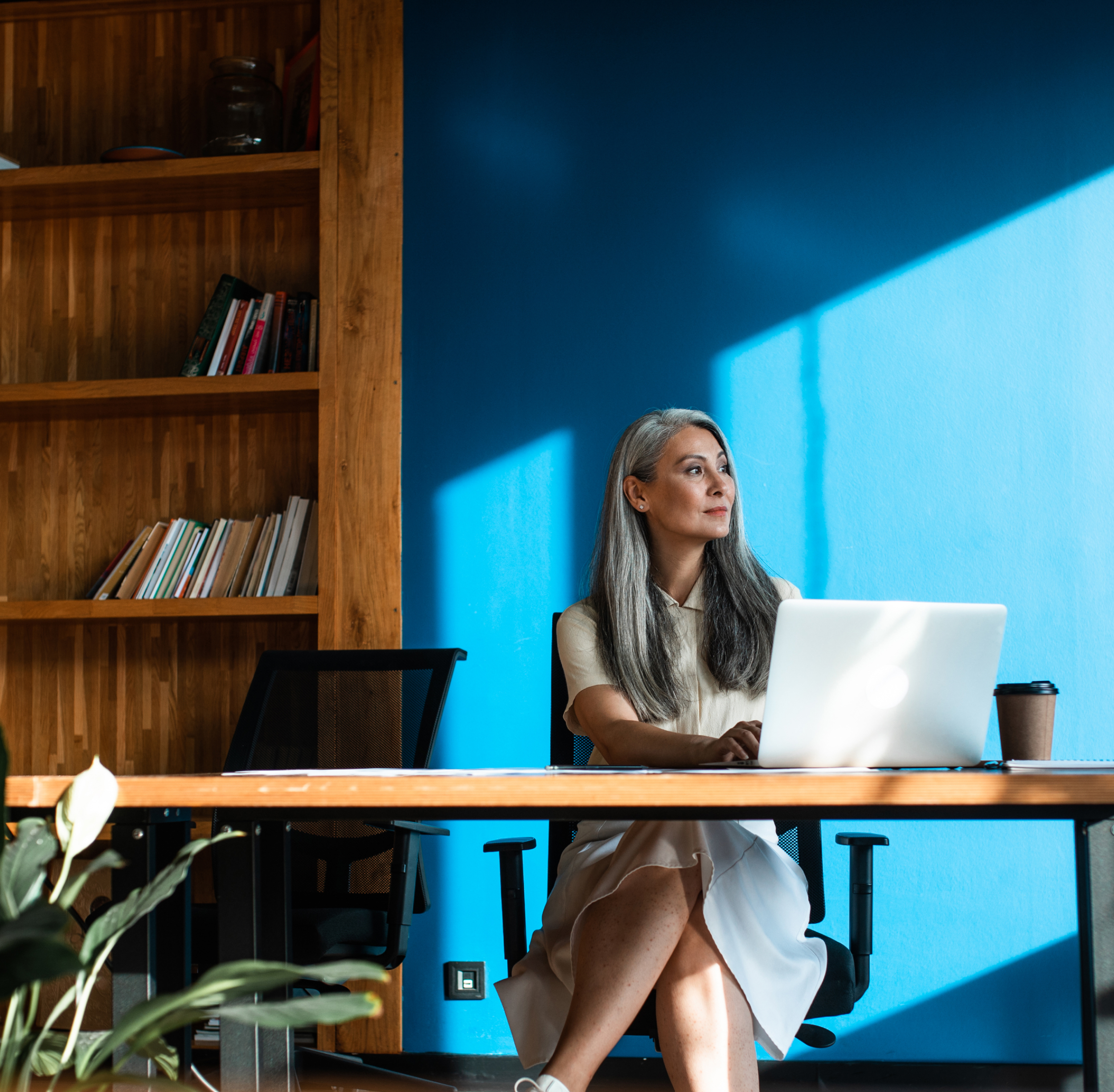 business woman sitting at desk in front of the computer