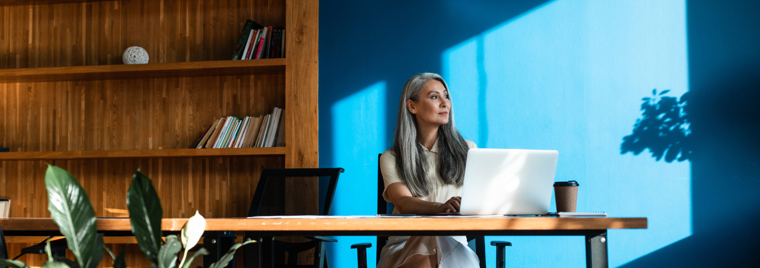 business woman sitting at desk in front of the computer
